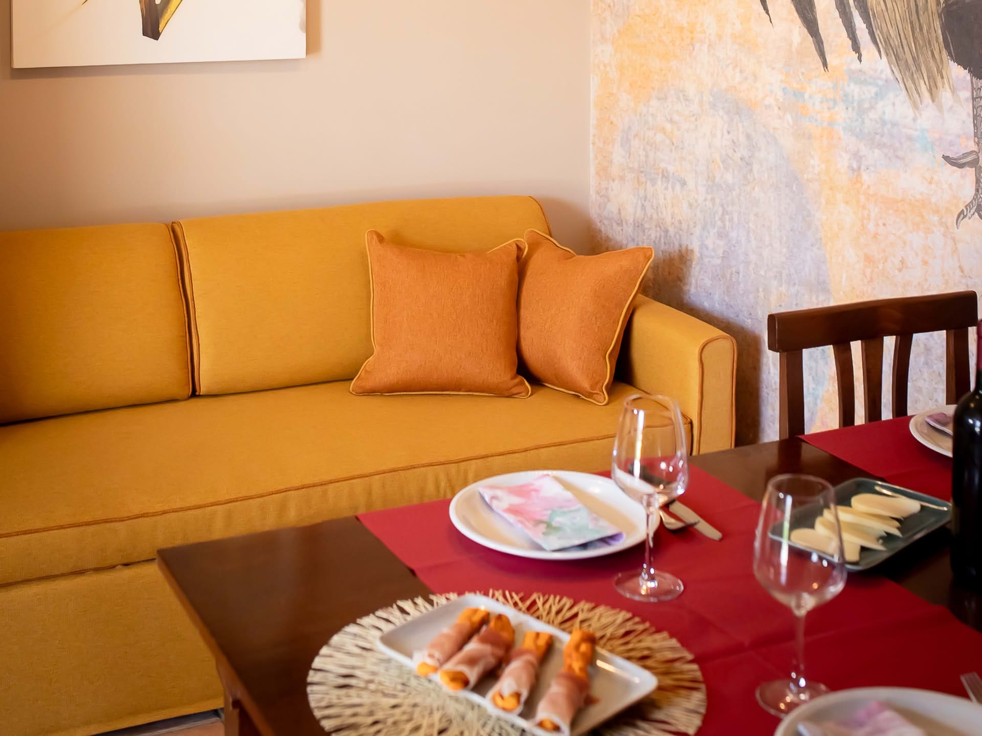 Detail of the dining area and sofa in the Olivo Apartment