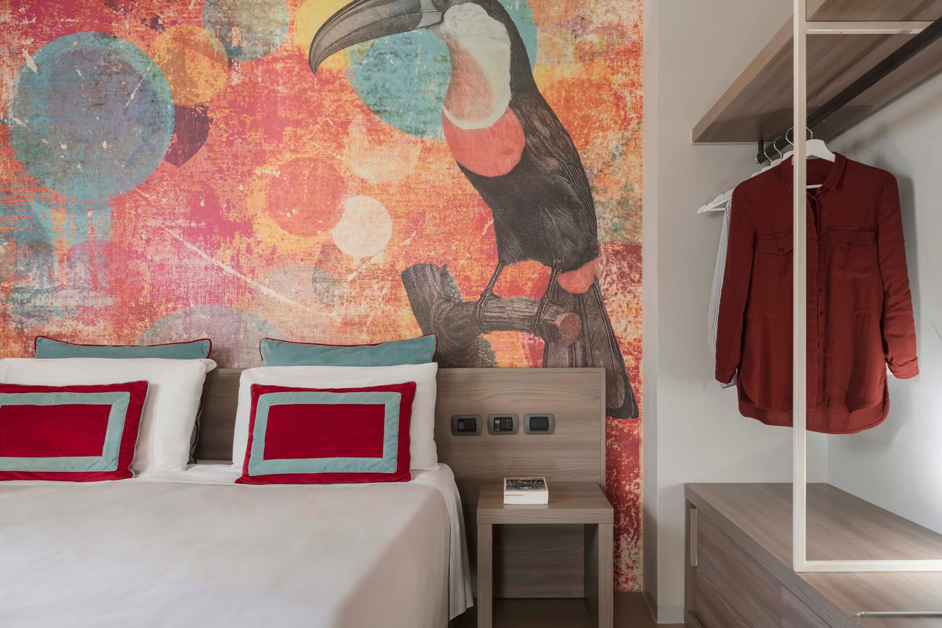 Detail of the double bed and wardrobe in the Garden Room at Casolare Terre Rosse