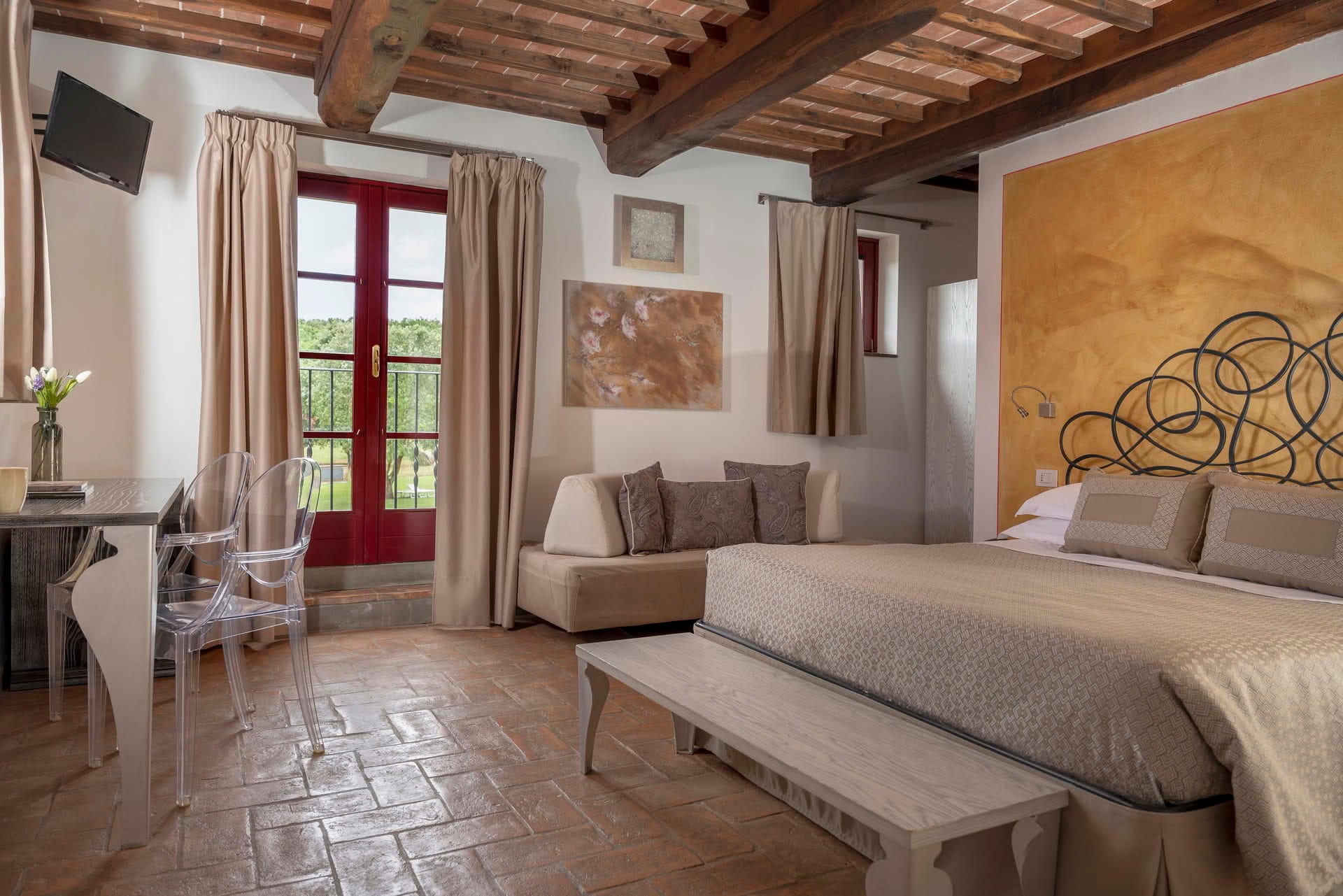 Deluxe Room with double bed, desk, and large window overlooking the garden