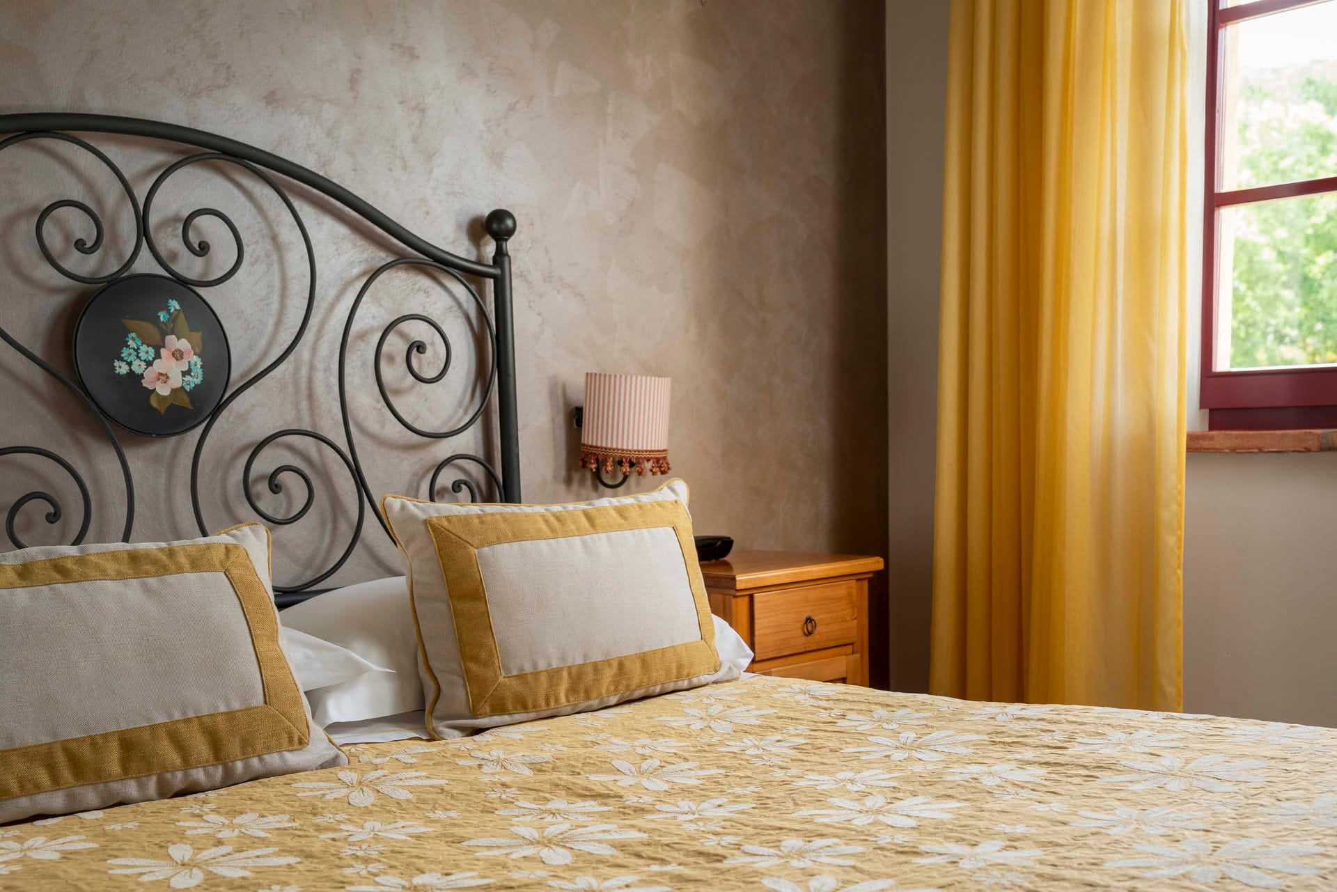 Detail of the bed in the Small Classic Room at Casolare Terre Rosse