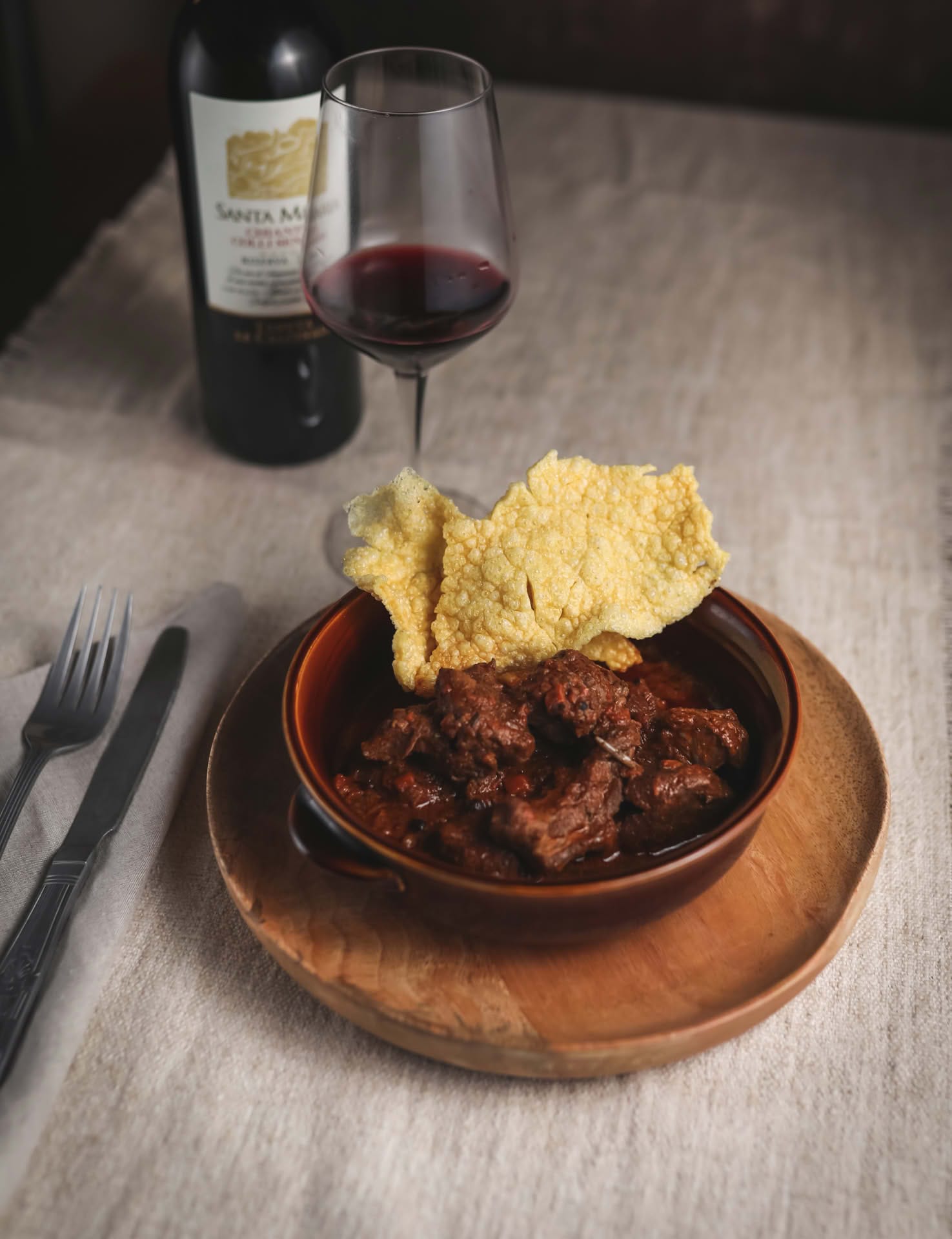 Detail of a dish and a glass of red wine at the Casolare Terre Rosse Restaurant