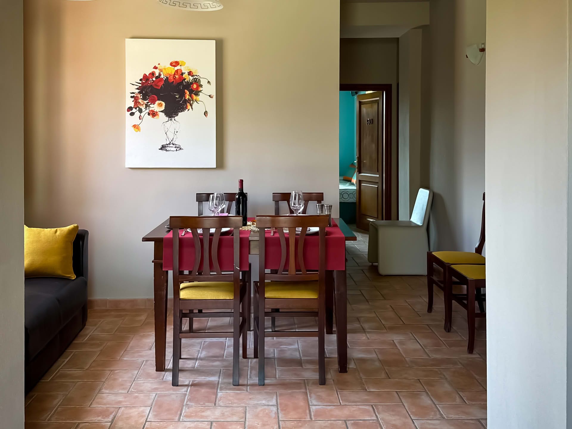 Detail of the set dining table in the Cipresso Apartment at Casolare Terre Rosse