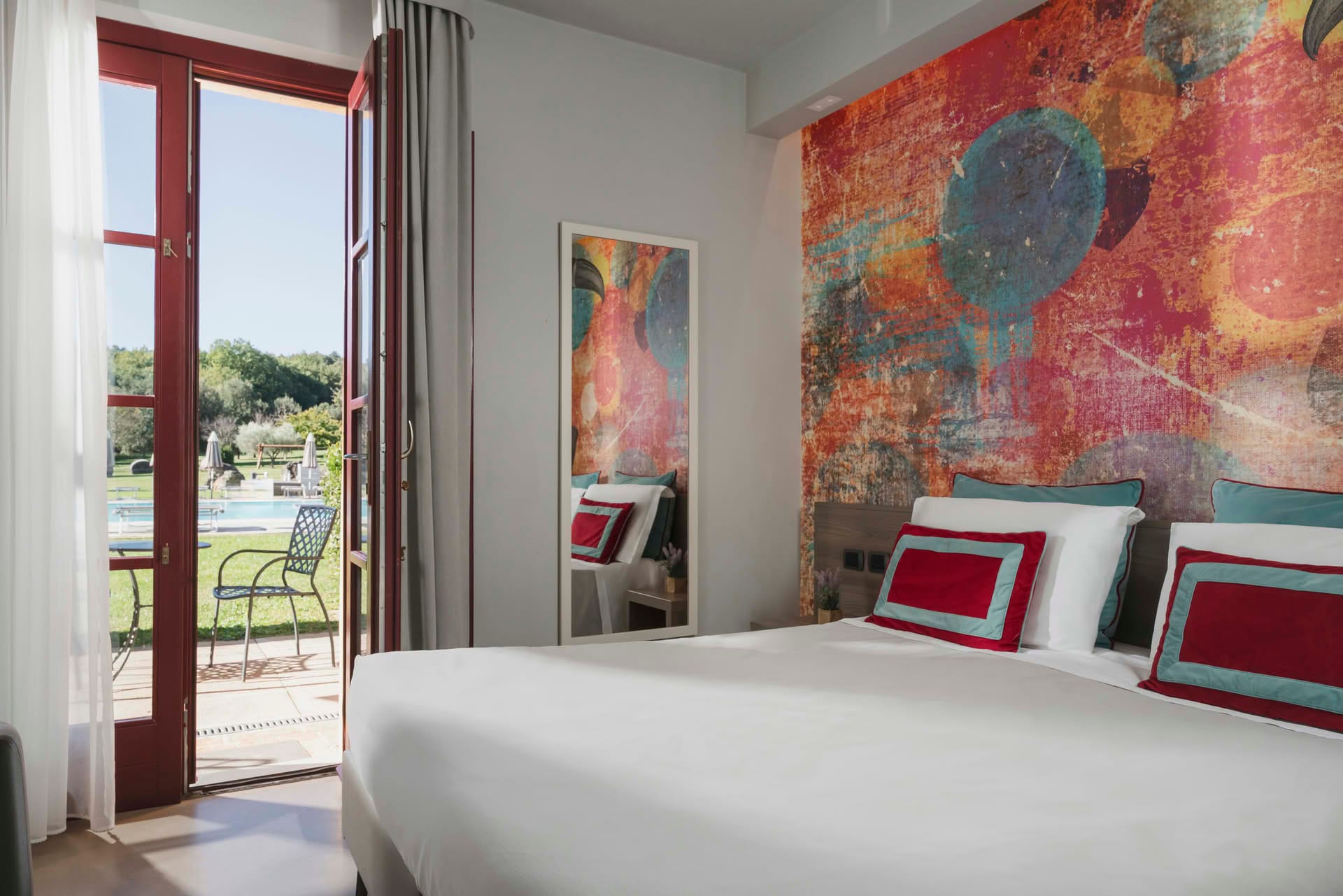 Detail of the Garden Room with large French door and double bed at Casolare Terre Rosse