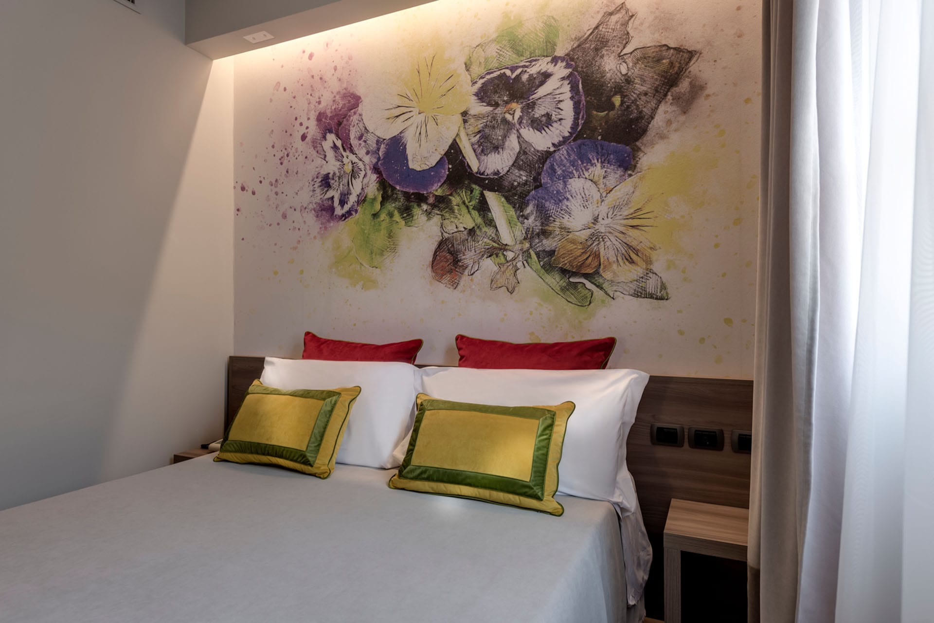 Detail of the double bed in the Basic Room at Casolare Terre Rosse