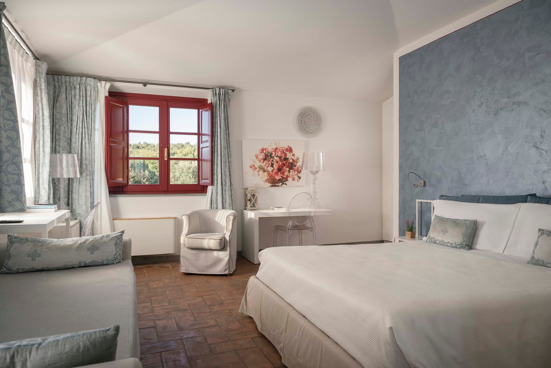 Deluxe Room with double bed, desk, and large window overlooking the garden